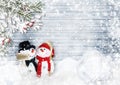 Christmas card with snowmen, holly and fir branches on wood Royalty Free Stock Photo