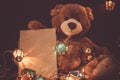 Christmas card with Teddy bear gifts and fairy lights garland Royalty Free Stock Photo