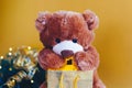 Christmas card with Teddy Bear opening gift and holiday decoration Royalty Free Stock Photo