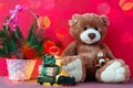 Christmas card with Teddy bear, gift, decorated christmas tree, fairy lights garland