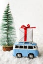 Christmas Card with vintage car and xmas gift in wintery landscape Royalty Free Stock Photo
