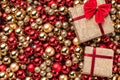 Christmas card. Wallpaper of red and gold baubles. Top view. Gifts packed on one side Royalty Free Stock Photo