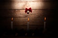 Christmas card: watch on a wooden background with candles with a