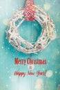 Christmas card with white wreath on a turquoise door Royalty Free Stock Photo