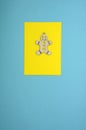 Christmas card. Wooden gingerbread man on yellow and blue background
