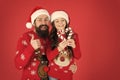 Christmas Carol. Father and daughter with candy canes christmas decorations. Family holiday. Santa claus family look Royalty Free Stock Photo