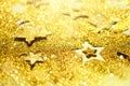 Christmas celebration. Abstract background for new year party. Patter of gold stars with lights, bokeh. Golden glitter stars on Royalty Free Stock Photo