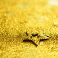 Christmas celebration. Abstract background for new year party. Patter of gold stars with lights, bokeh. Square crop. Golden