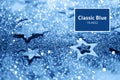 Christmas celebration. Abstract background for new year party. Patter of gold stars with lights, bokeh. Trendy blue and