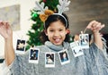 Christmas, celebration and girl with polaroid for decoration, happy and show photos in the house. Smile, excited and