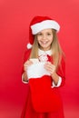 Christmas celebration ideas. Child Santa Claus costume hold stocking. Happy smiling face. Emotional baby. Good vibes