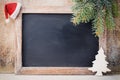 Christmas chalkboard and decoration over wooden background.