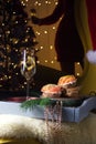 Christmas champagne with red fish appetizer and Christmas tree against the background of a silhouette of a woman