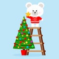 Christmas character: cute polar bear in red sweater puts star on a top of decorated christmas tree Royalty Free Stock Photo