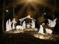 Christmas characters in a manger. Christmas decoration in the park on a dark background. Nativity scene with backlight. Concept: Royalty Free Stock Photo