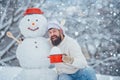 Christmas chef. Man in snow. Man with snowman in winter kitchen. Handsome Santa Claus cook.