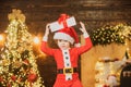 Christmas child. Cute little child near Christmas tree. Happy little child dressed in winter clothing think about Santa Royalty Free Stock Photo