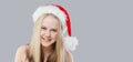 Christmas child girl wearing red Santa hat against gray studio wall banner background Royalty Free Stock Photo