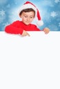 Christmas child kid boy Santa Claus pointing empty banner sign portrait format copyspace Royalty Free Stock Photo