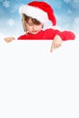 Christmas child kid girl Santa Claus pointing empty banner portrait format snow copyspace
