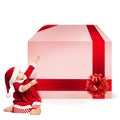 Christmas Child in Santa Hat and Big Gift Box Royalty Free Stock Photo