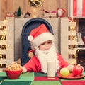 Christmas child. Thanksgiving day and Christmas. Santa Claus. Santa boy child eating cookies and drinking milk. Royalty Free Stock Photo