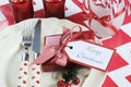 Christmas children family party table place settings in red and white theme Royalty Free Stock Photo