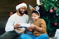 Christmas, children and gift with a father and daughter in celebration of the festive season together. Kids, happy and Royalty Free Stock Photo