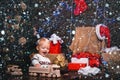 Christmas childs in snow. Happy small kids in santa hat with present have a christmas. Cute little child is decorating