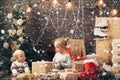 Christmas childs in snow. Happy small kids in santa hat with present have a christmas. Winter evening at home. Opening