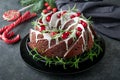 Christmas chocolate bundt cake. Traditional Christmas fruit cake with white glaze, cranberries and rosemary on dark backgroundChri Royalty Free Stock Photo