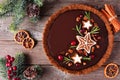 Christmas chocolate gingerbread pie. Top down view table scene over a dark wood background.