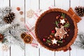 Christmas chocolate gingerbread tart. Overhead view table scene with a white wood background. Royalty Free Stock Photo