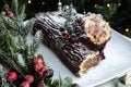 Christmas chocolate log, Buche de Noel, festive holiday cake and decorations Royalty Free Stock Photo