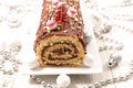 Christmas chocolate swiss roll and decoration Royalty Free Stock Photo