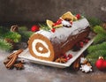 Christmas chocolate Yule log cake at the table. Christmas food concept