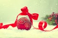 Christmas. Christmas and New Year Holiday Background with Red Bauble, Ribbon, Snow and Snowflakes. Vintage style Royalty Free Stock Photo