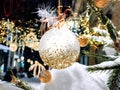 Christmas City decoration pine tree branch with white  ball and illumination ,snowfall,people walk on snowy street in medieval Tal Royalty Free Stock Photo