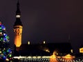 Christmas city market place in Tallinn town Hall Square fireworks , Illuminated tree,night light blurred ,people walking ,New year Royalty Free Stock Photo