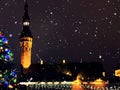 Christmas city market place in Tallinn town Hall Square fireworks , Illuminated tree,night light blurred ,people walking ,New year Royalty Free Stock Photo