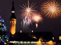 Christmas city market place in Tallinn town Hall Square fireworks , Illuminated tree,night light blurred ,people walking ,New year Royalty Free Stock Photo