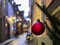 Christmas city  street life ,green tree decorated with red balls and illumination, evening blurred light ,people walking  ,holiday Royalty Free Stock Photo