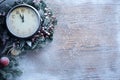 Christmas clock over snow wooden background.