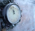 Christmas clock over snow wooden background. Royalty Free Stock Photo