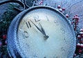 Christmas clock over snow wooden background. Royalty Free Stock Photo