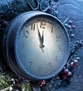 Christmas clock over snow wooden background. Royalty Free Stock Photo