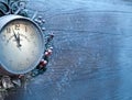 Christmas clock over snow wooden background.