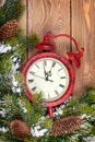 Christmas clock over wooden background with snow fir tree Royalty Free Stock Photo