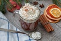 Christmas cocoa with whipped cream, chocolate, walnuts, cinnamon