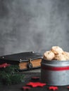 Christmas coconut meringue cookies in metal box and old bible on background.